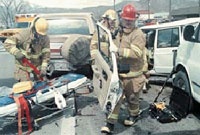 Firefighters at the scene of a motor vehicle accident, March 22, 2001